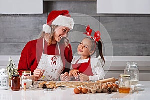 Mother and daughter making Christmas cookies in the kitchen