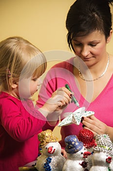 Mother and daughter making Christmas decorations