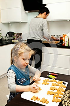 Mother and daughter making gingerbread cookies at home