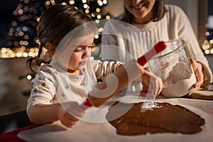 mother and daughter making gingerbread at home