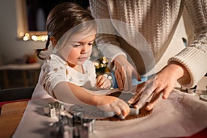 mother and daughter making gingerbread at home