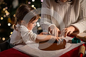 mother and daughter making gingerbread at home