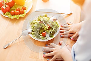 Mother and daughter making salad