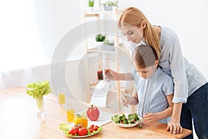 Mother and daughter making salad