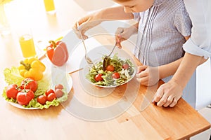 Mother and daughter making salad