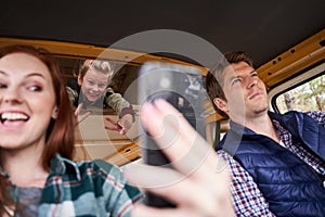 Mother and daughter making selfie in the car