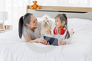 Mother and daughter with Maltese.