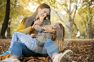 Mother and daughter in meadow. Mother and daughter having fanny