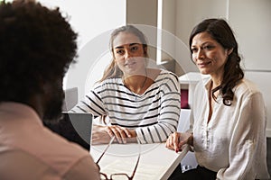 Mother And Daughter Meeting With Male Teacher