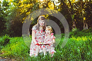 Mother and daughter on nature book