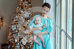 Mother and daughter near a Christmas tree