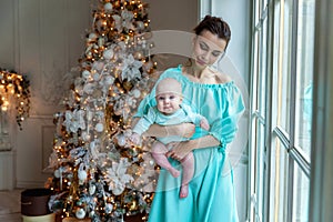 Mother and daughter near a Christmas tree