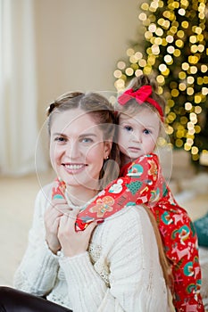 Mother and daughter near Christmas tree