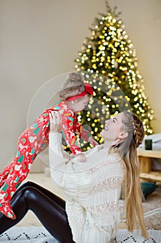 Mother and daughter near Christmas tree