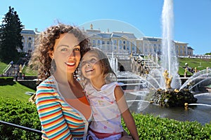 Mother with daughter near fountains of Petergof