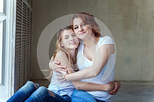 Mother and daughter near the windiow photo