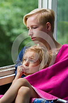 Mother and daughter near the window