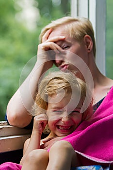 Mother and daughter near the window