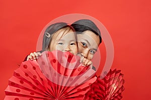 Mother and daughter with paper fans