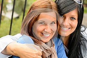 Mother and daughter in the park smiling