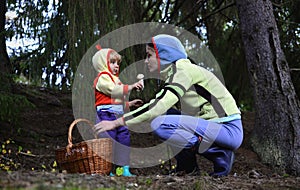 Mother and daughter picking mushrooms