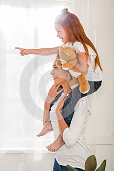 Mother and daughter piggybacking