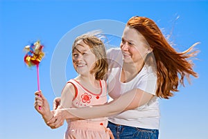 Mother and daughter with pinwheel