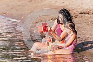 Mother and daughter playing on beach