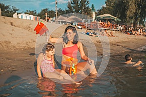 Mother and daughter playing on beach