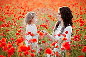 Mother and daughter playing in flower field