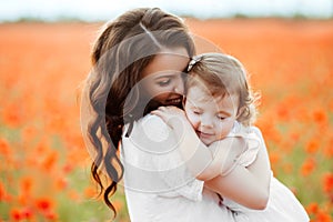 Mother and daughter playing in flower field