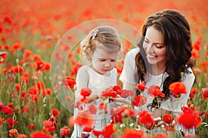 Mother and daughter playing in flower field