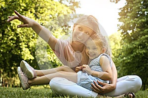 Mother and daughter outdoors in a meadow.