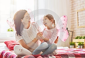 Mother and daughter playing and hugging