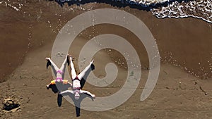 mother and daughter playing on the sandy beach. Happy family on the sandy seashore