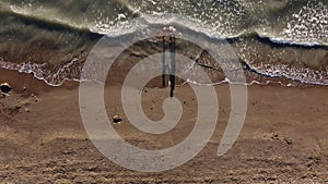 mother and daughter playing on the sandy beach. Happy family on the sandy seashore