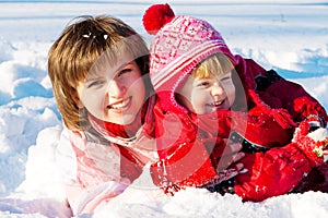 Mother and daughter playing in snow