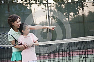 Mother and daughter playing tennis