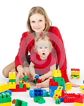 Mother and daughter playing together blocks