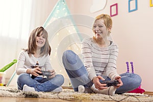 Mother and daughter playing video games