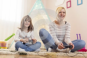 Mother and daughter playing video games