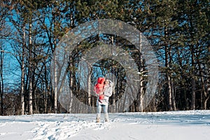 Mother and daughter playing on winter park