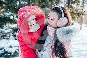 Mother and daughter playing on winter park