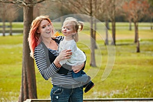 Mother and daughter playint together in park