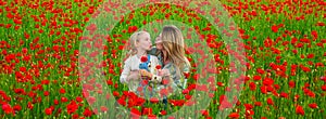 Mother and daughter on the poppies field background. Spring family banner. Happy family resting on a beautiful poppy