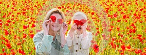 Mother and daughter on the poppies field background. Spring family banner. Poppies meadow with poppys flowers. Closing