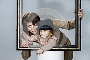 Mother and daughter posing with frame