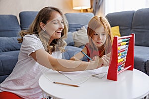 Mother and daughter practicing math using abacus