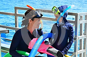 Mother and daughter prepare to snorkeling dive