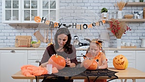 Mother with Daughter Preparing for Halloween